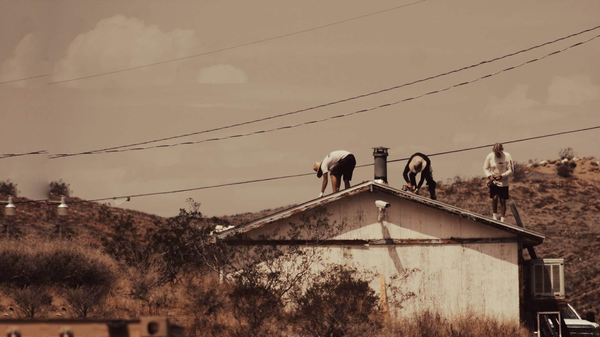 people fixing roof